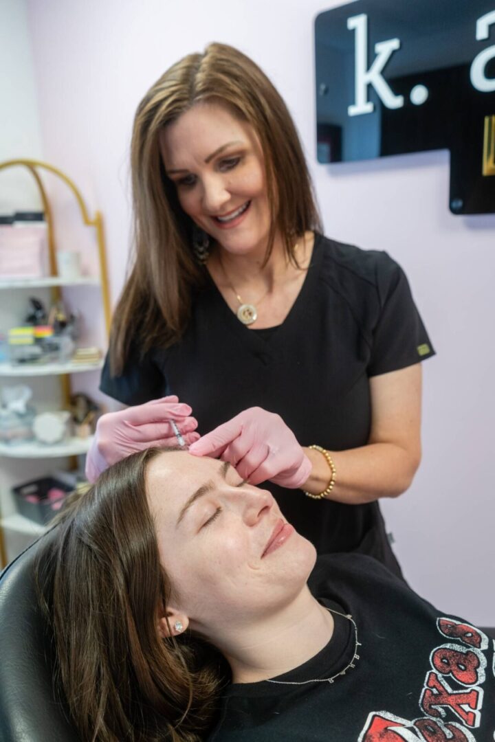 A woman is getting her hair cut by another person.